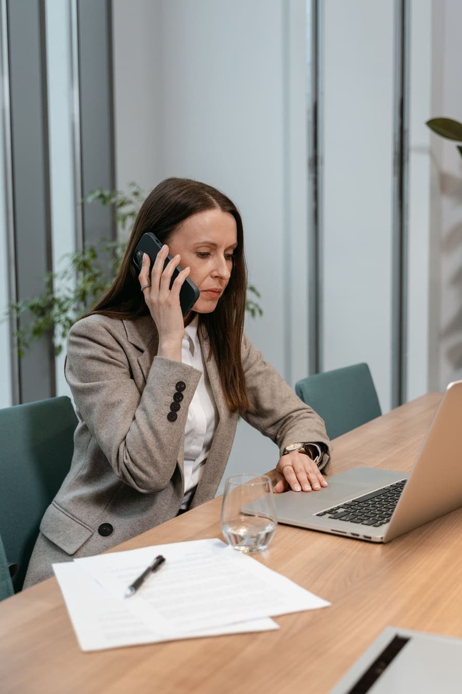 Professional handling a client call from a laptop